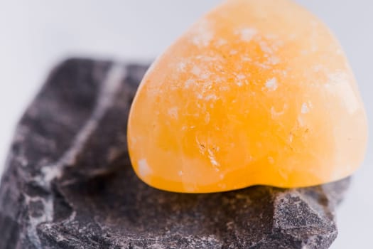 Natural stone carnelian shines in beautiful colors on a white background