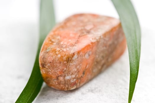 Natural stone unakite shines in beautiful colors on a white background