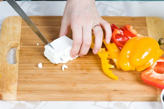 Preparation of salad from cheese and fresh vegetables