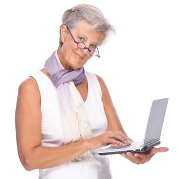Studio shot of an active senior woman using a notebook