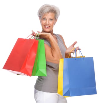 Studio shot of active senior woman with shopping bags