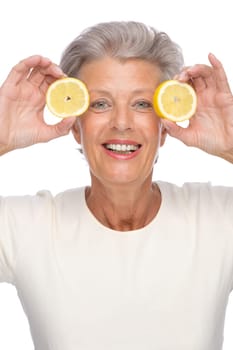 Studio shot of an active senior woman with a lemon
