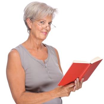 Studio shot of an active senior woman with a book