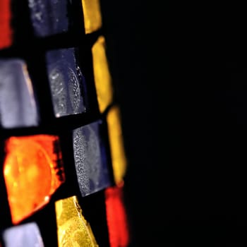 Colorful stained glass abstract shapes background. Selective focus.
