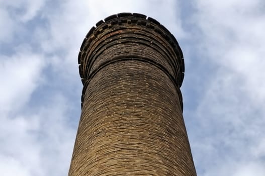 Weathered brick chimney of an abandoned factory.