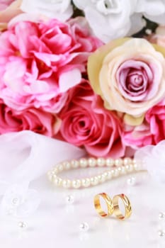 Wedding still life with beautiful golden rings and bouquet