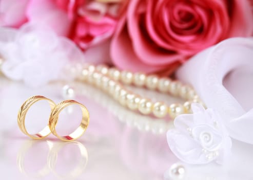 Wedding still life with beautiful golden rings and bouquet