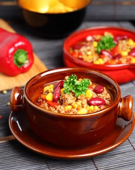 Bowl of chili with peppers and beans
