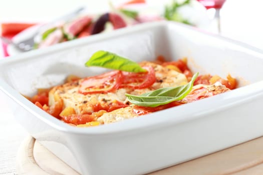 Baked feta cheese with hot salsa sauce with salad