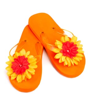 orange flip-flops with flowers on a white background