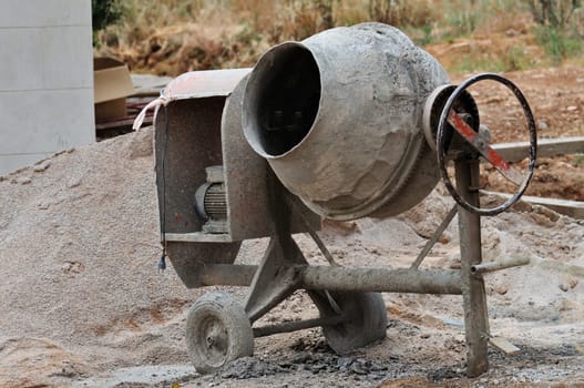 Industrial cement mixer machine at construction site.