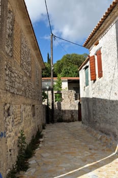 Narrow street and traditional houses in village Louha in the island of Zakynthos, Greece.