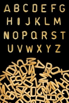 Alphabet soup pasta font. Kids food background.