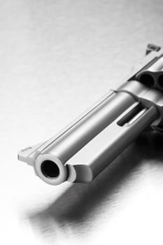 gun on steel - modern revolver closeup, focus on muzzle