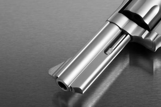 gun on metal - modern revolver handgun on stainless steel surface