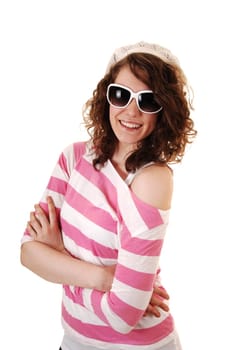 An young happy woman in a striped sweater a knitted hat and  sunglasses standing for white background.