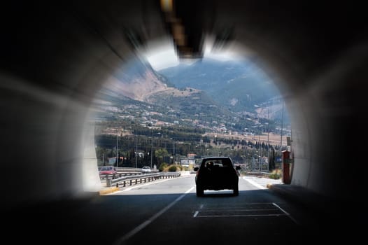Cars speeding through highway tunnel. Motion blur.
