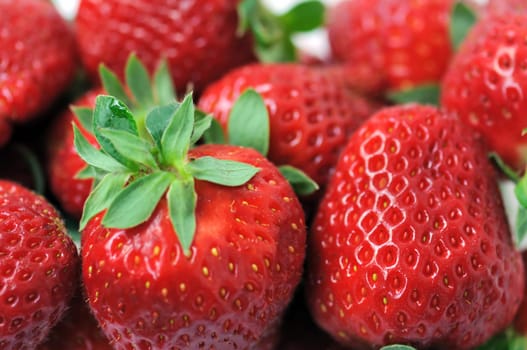 Fresh strawberries with stem background. Selective focus macro.