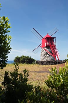 Red windmill in the coast of Pico island, Azores
