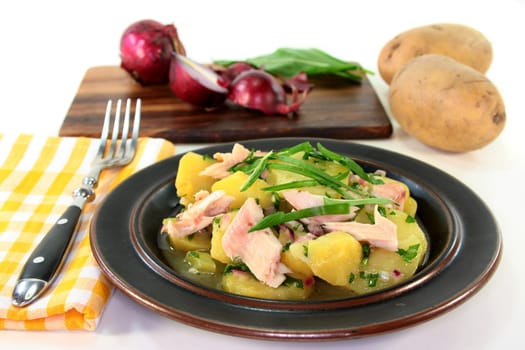 Wild garlic and potato salad with smoked fish