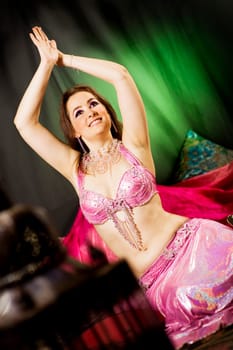 oriental woman laying on the floor with a pink dress and veils