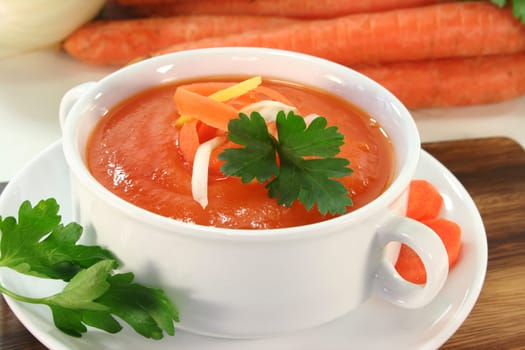 a bowl of carrot soup with fennel and lemon