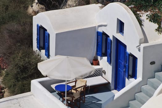 traditional house with blue doors and windows