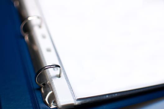 Detail of Blue Open File Folder With Blank Papers, shallow depth of field
