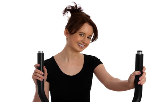 Young pretty woman exercising on a stepper