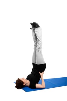 Young woman making a candle on a blue yoga mat