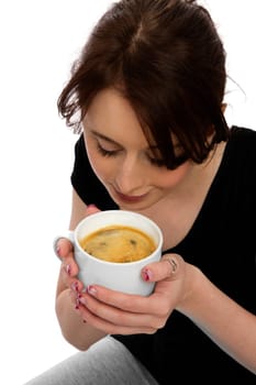 Young pretty woman holding coffee cup and smelling coffee
