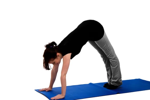 A young woman exercising on a blue yoga mat