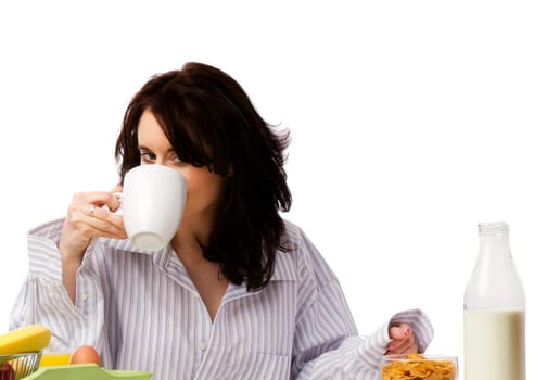 Young pretty woman drinking coffee at breakfast