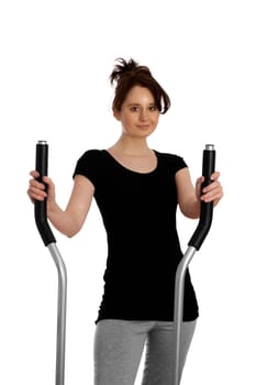 Young pretty woman exercising on a stepper