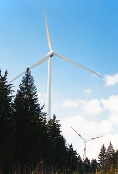 Twi Wind Turbines standing in a Forest