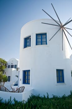 White Windmill with blue Windows in GreeceWhite