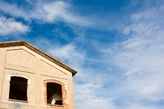 image of an abandoned and ruined house with the sky as the background
