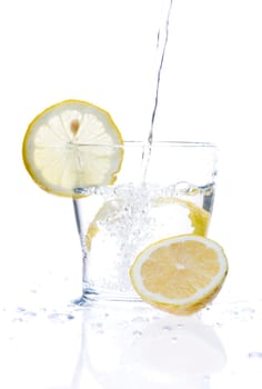 glass of liquid with lemon isolated over a withe background