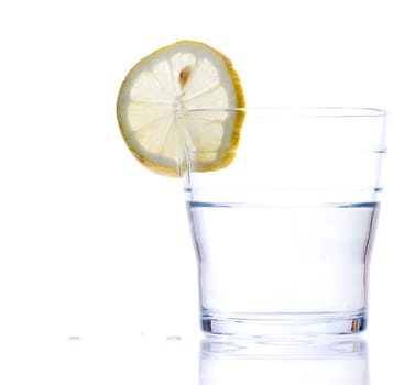 glass of liquid with lemon isolated over a withe background