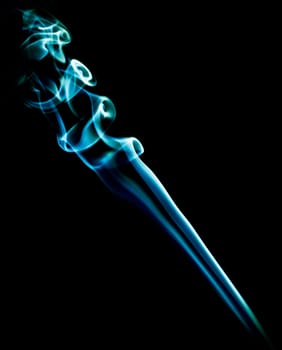 beautiful patterns created with the smoke of a bar of inciense and colorized over a black background