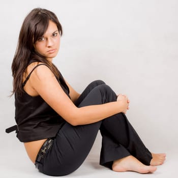 young cute young girl sitting on the floor