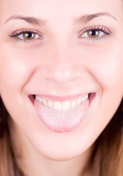 a young pretty girl showing her thongue as a joke