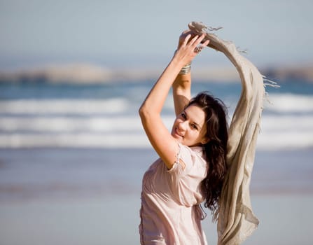 a young pretty girl with a scarf in a beach in a sunny beach