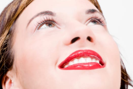joyful simle of a beautiful young girl with sexy red lips looking upwards
