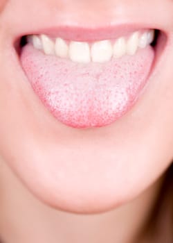 a young pretty girl showing her thongue as a joke