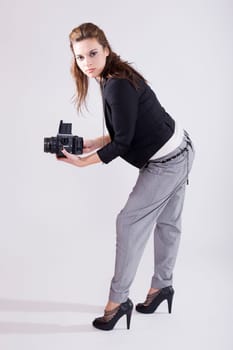 beautiful young photographer with a medium format fillm camera