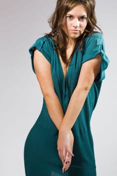 real young beautiful girl posing over a grey background