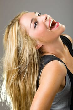 a beautiful blonde girl smiling and showing perfect teeth