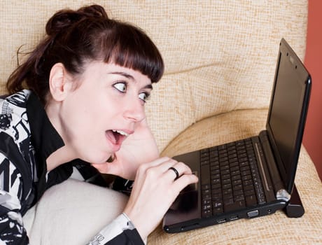 a real young woman typing in the keypad of a laptop