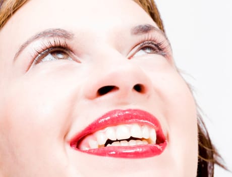 joyful simle of a beautiful young girl with sexy red lips looking upwards